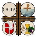 Collage of four circular logos on a wooden cross, including the OCIA emblem (top left) and agricultural symbols.